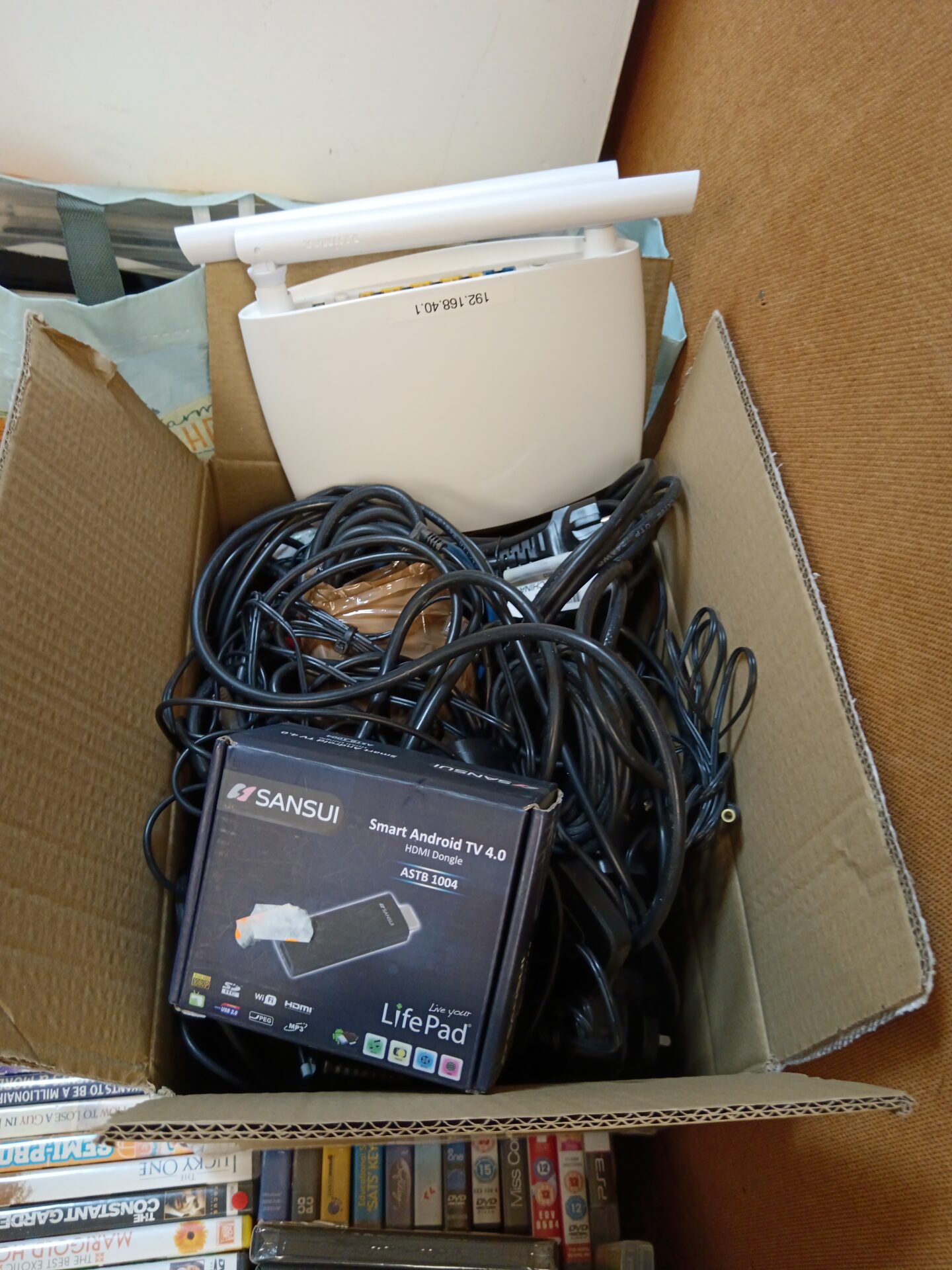 Box of cables & power supplies including sansui smart android TV 4.0