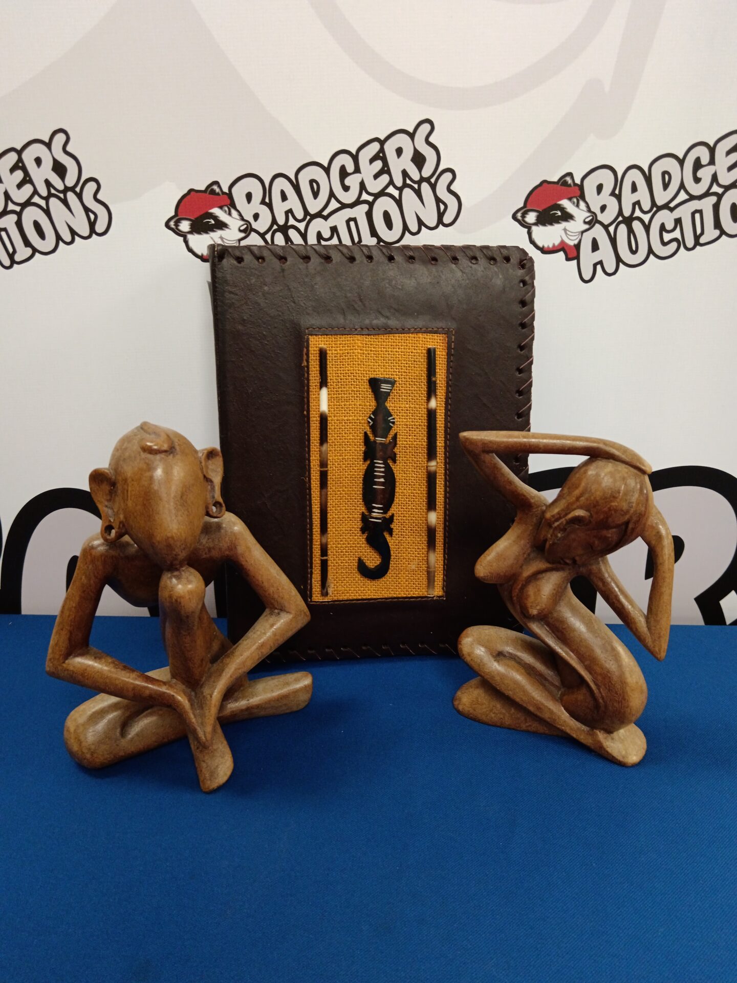 Two carved wooden African figures & leather bound photo album