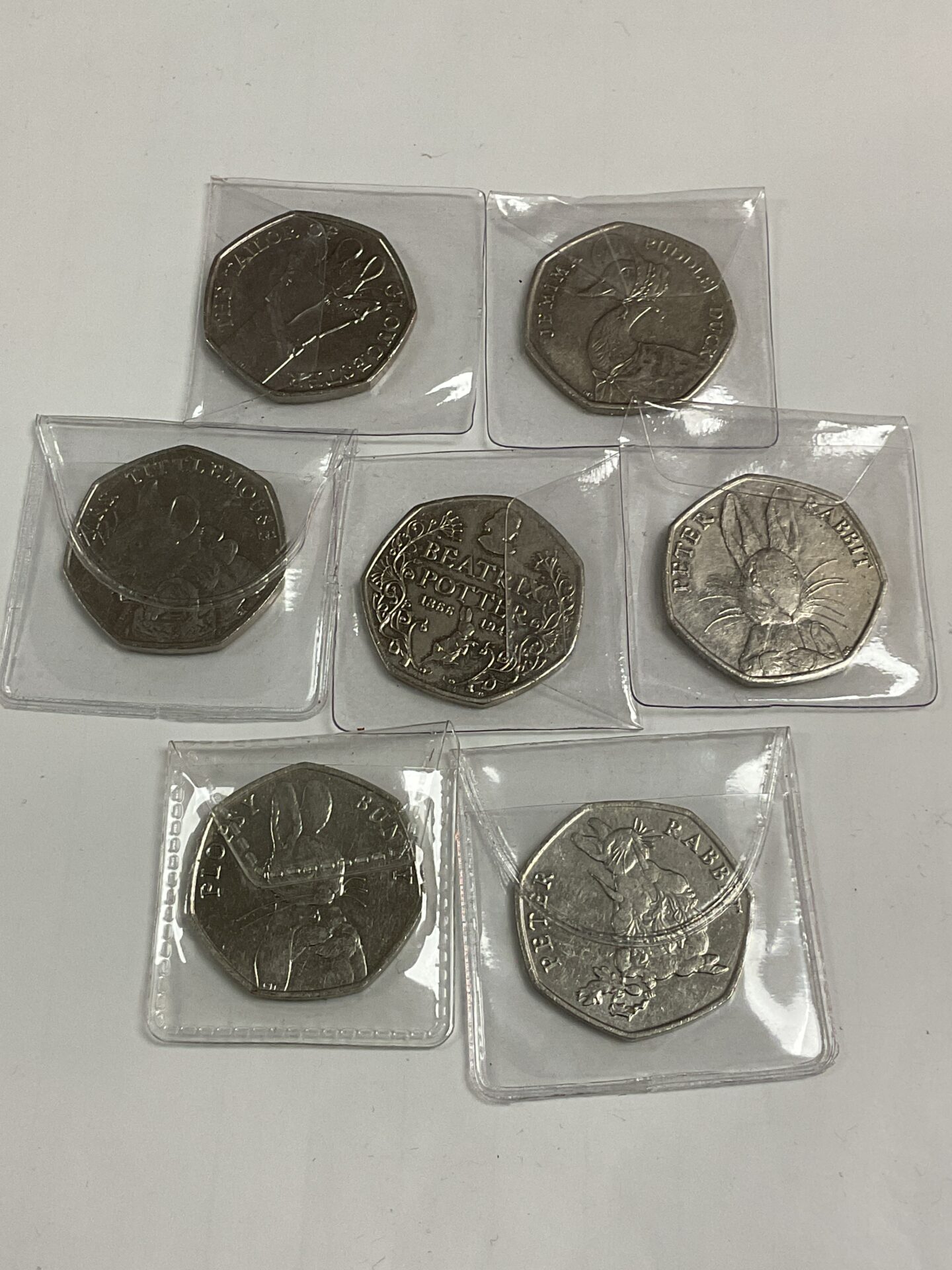Seven Beatrix Potter First Peter Rabbit 50p Coins and Floppsy Bunny