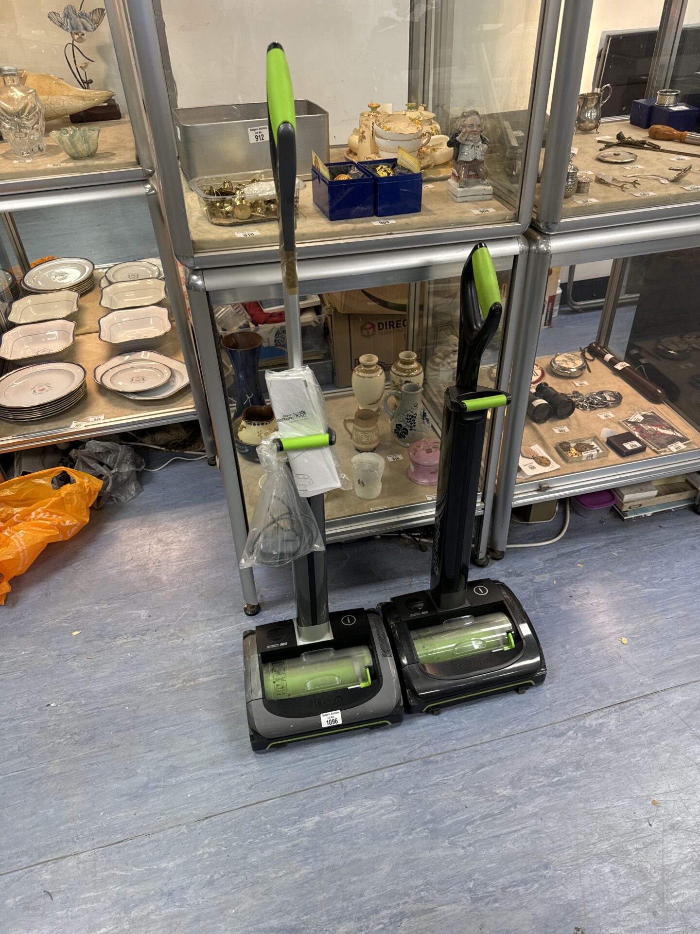 Two gtech cordless hoovers with one charger - untested, handle repaired with tape on one