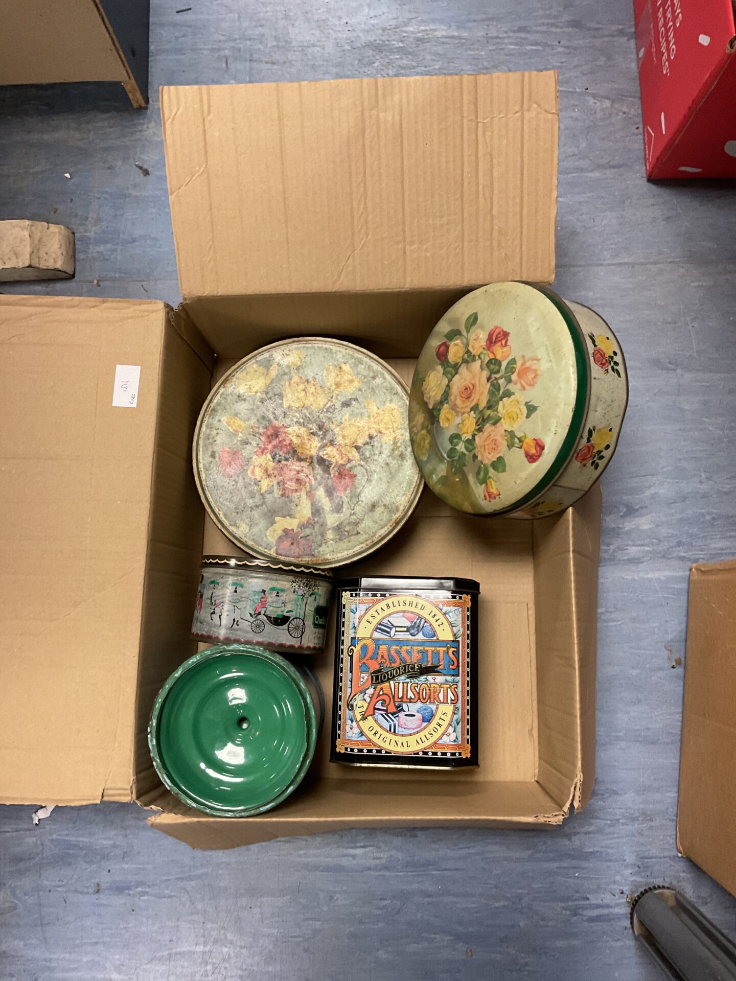 Box of empty vintage tins