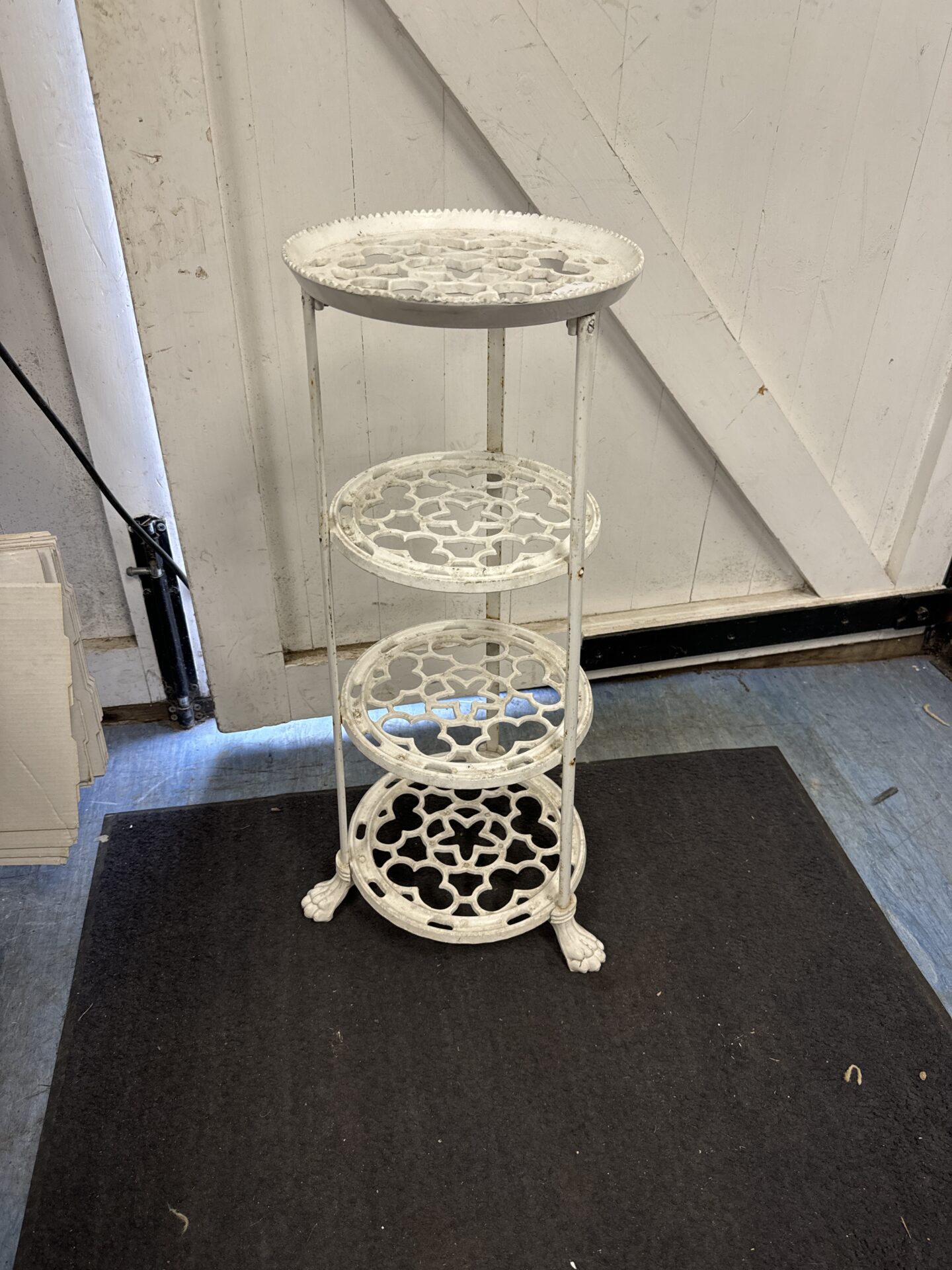 Four tier painted wrought iron plant pot stand