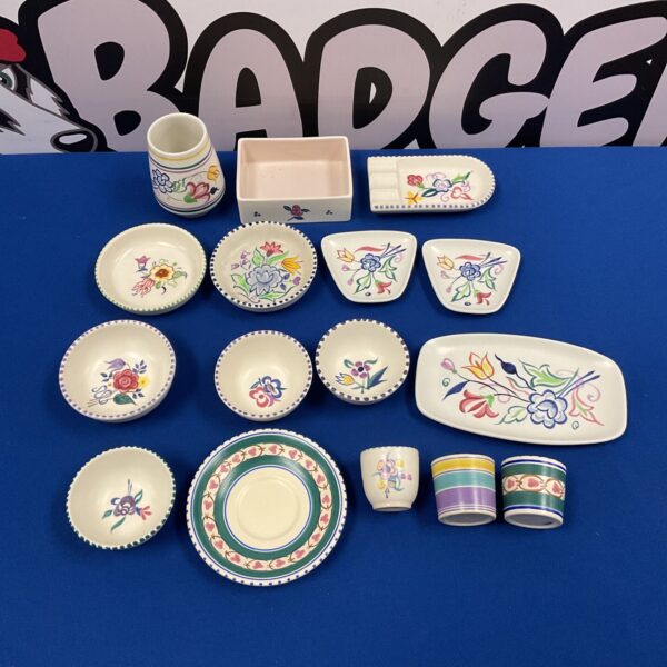 A set of vibrant ceramic plates, bowls, and cups with decorative patterns.